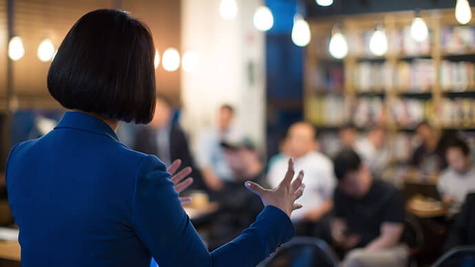 Woman presenting to conference audience